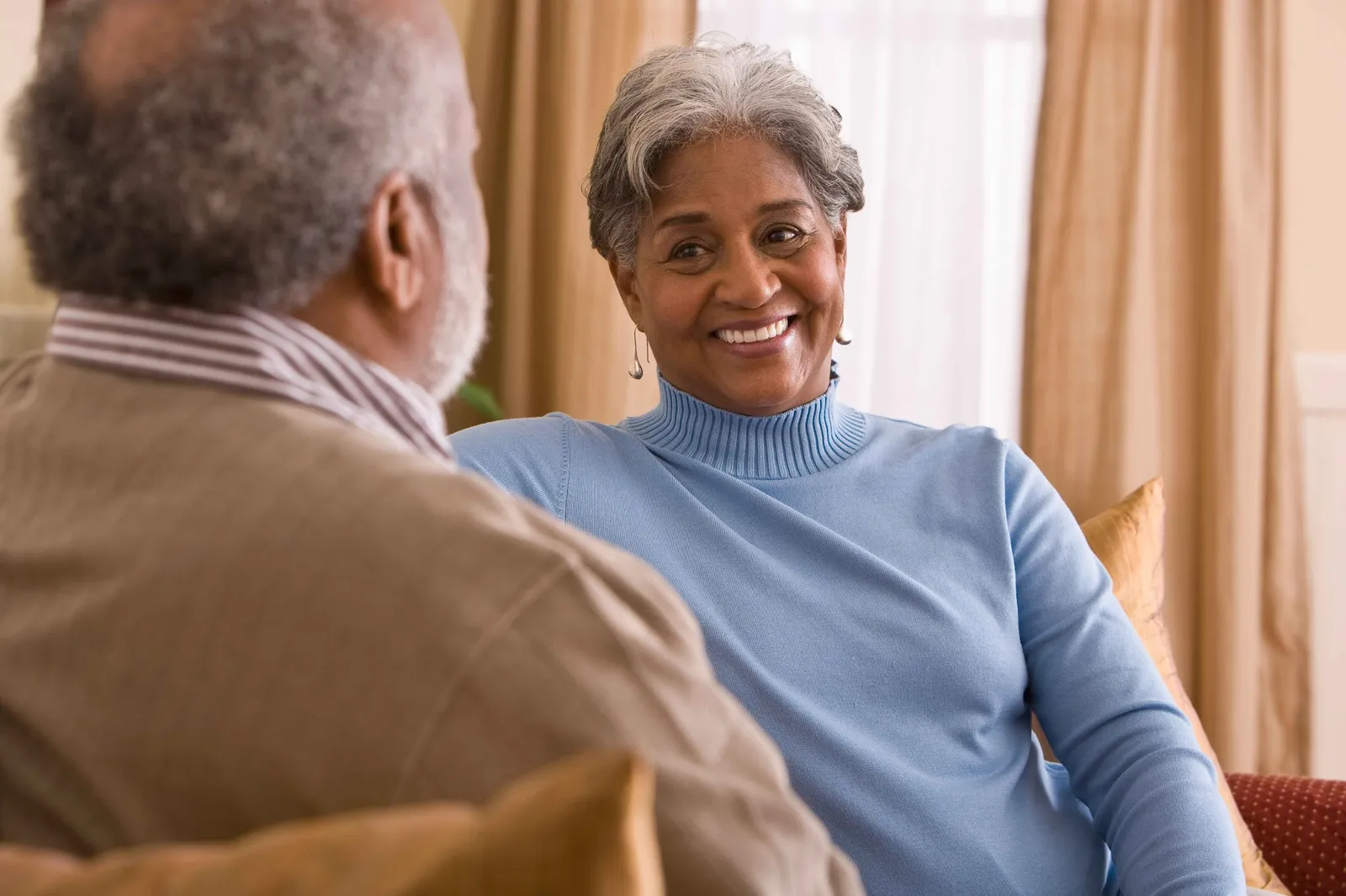 Woman smiling confidently after replacing missing teeth