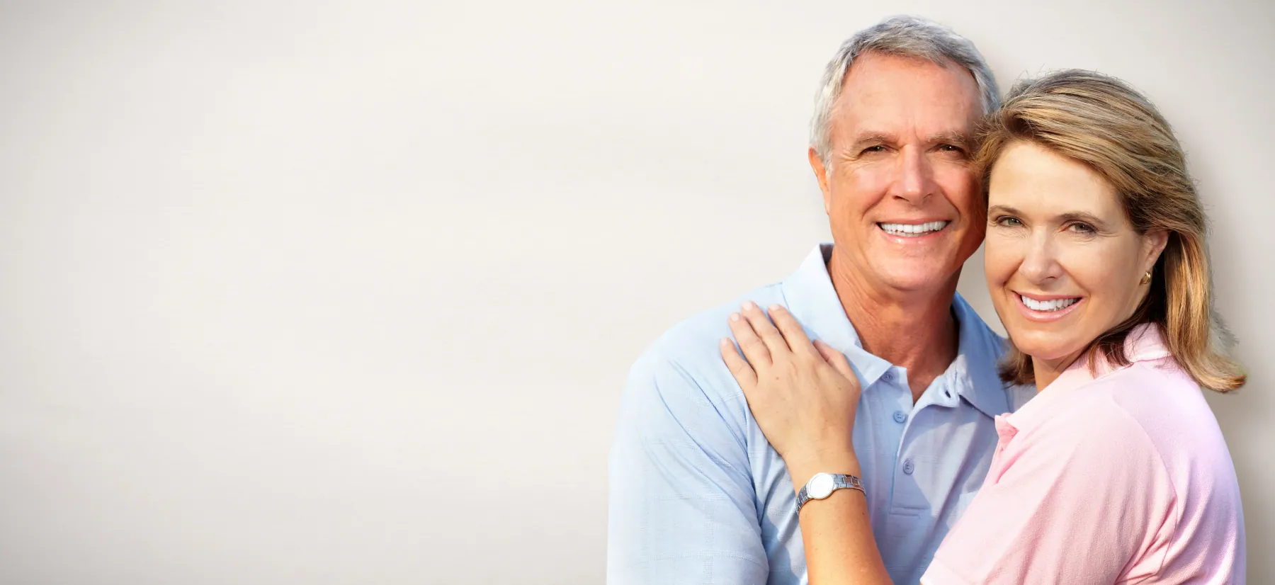 Mature couple smiling after implant treatment with bone grafting at Hacton Dental Care in Hornchurch