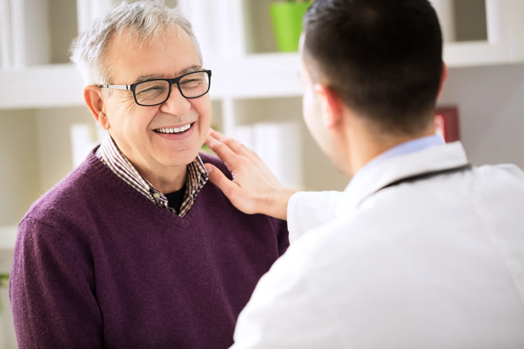 Older Hornchurch patient laughing with relief after specialist endodontic treatment